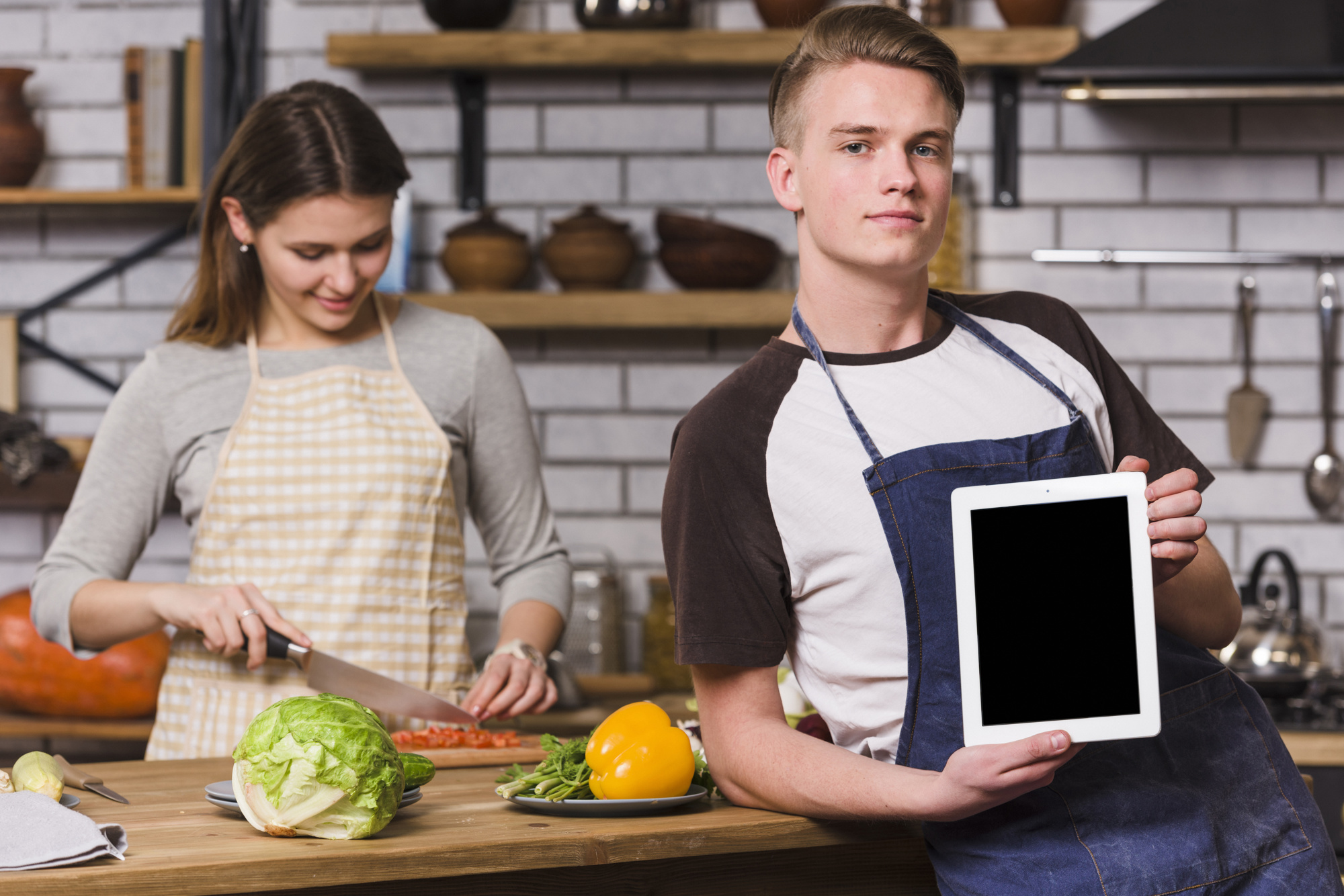 Student in modern kitchen teaching via tablet