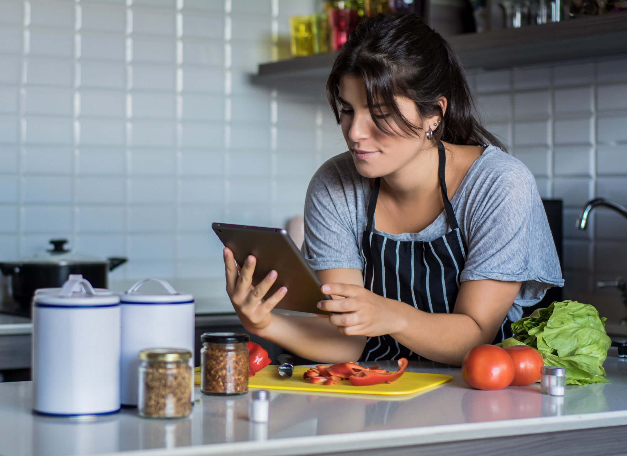 Student using tablet while cooking