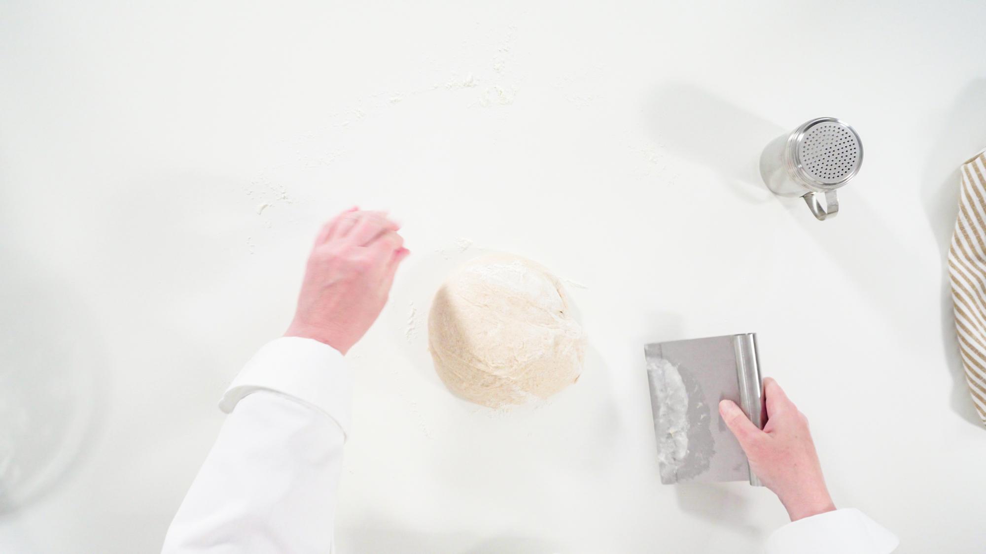 Hands preparing dough with precision